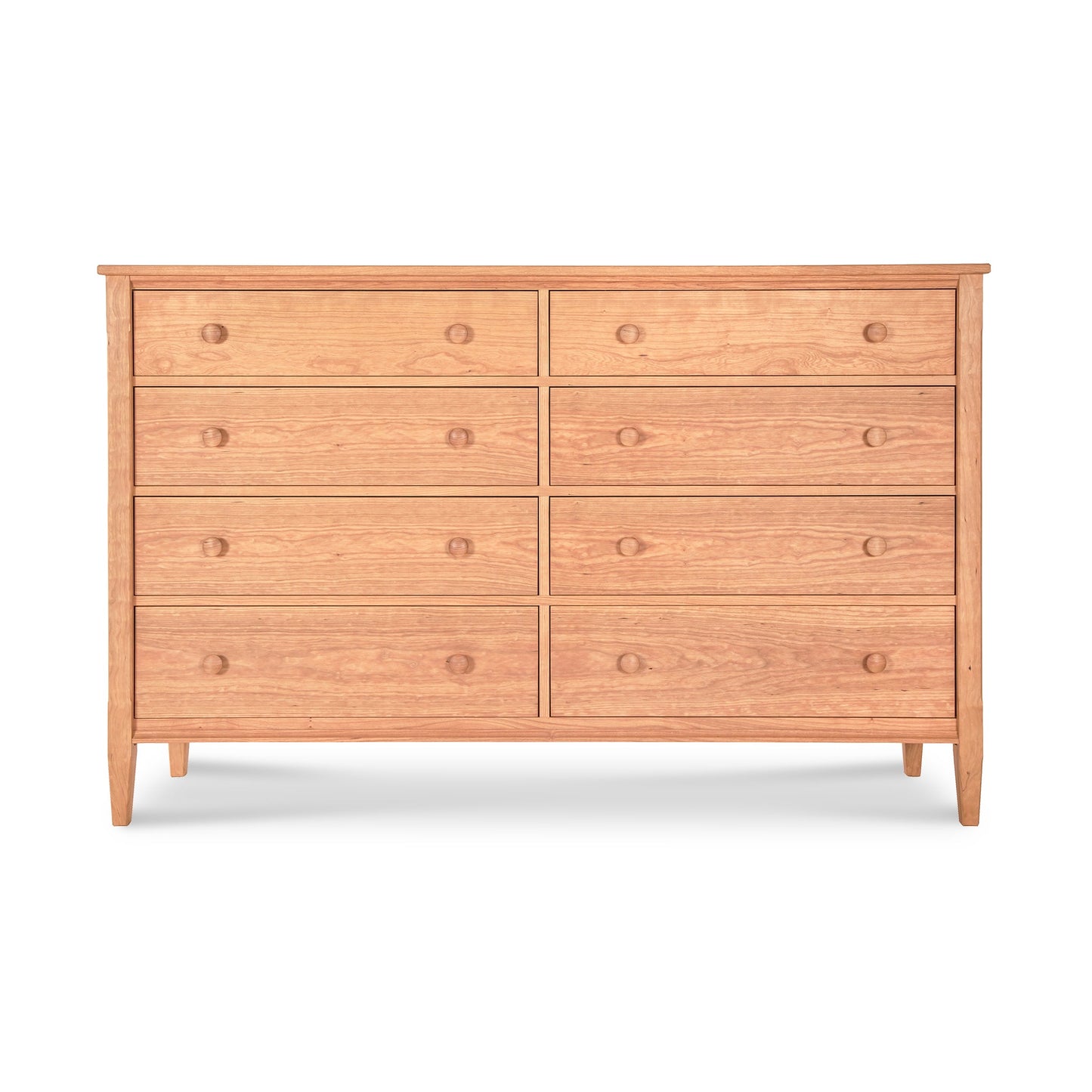 A Vermont Shaker 8-Drawer Dresser from Maple Corner Woodworks, featuring a light brown finish and round knobs. It has two smaller drawers on top of six larger ones, all against a plain white background.