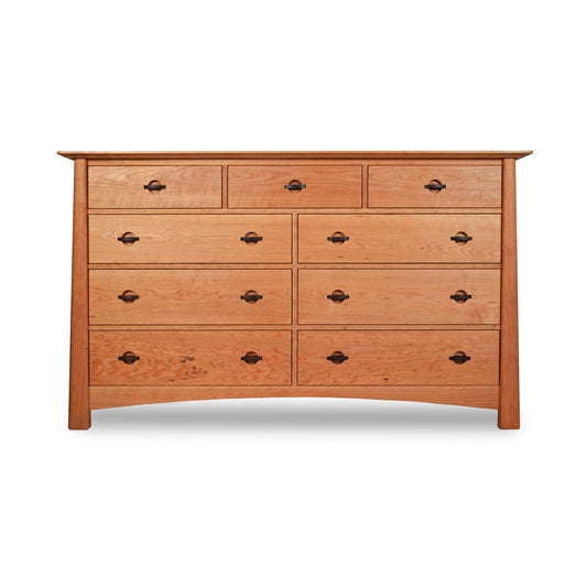 A Cherry Moon 9-Drawer Dresser with a light brown finish featuring two rows of small drawers at the top and two larger rows of drawers below, each with round metal handles, against a white background. This eco-friendly dresser by Maple Corner Woodworks.
